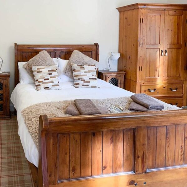 Double bedroom with sleigh bed, Sluice Keeper's Cottage, Dornoch