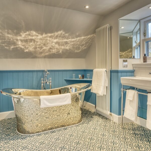 White and blue ensuite bathroom with stainless steel bathtub, The Meadows, Dornoch