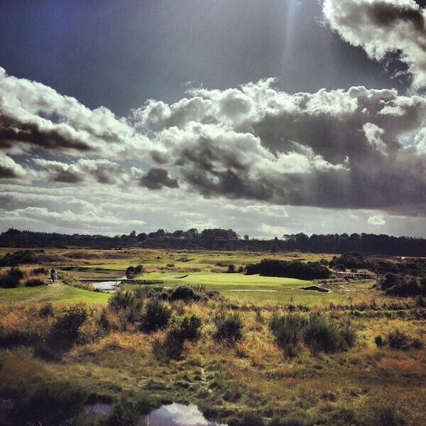 Image of 16th hold on Tain Golf Course on bright sunny day with low clouds