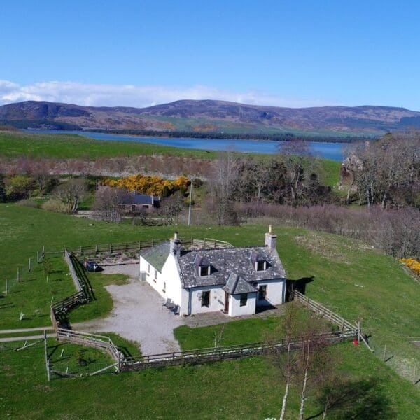 Aerial shot of Grieve's Cottage, Skelbo Dornoch overlooking garden and north over Loch Fleet to Ben Bhraggie