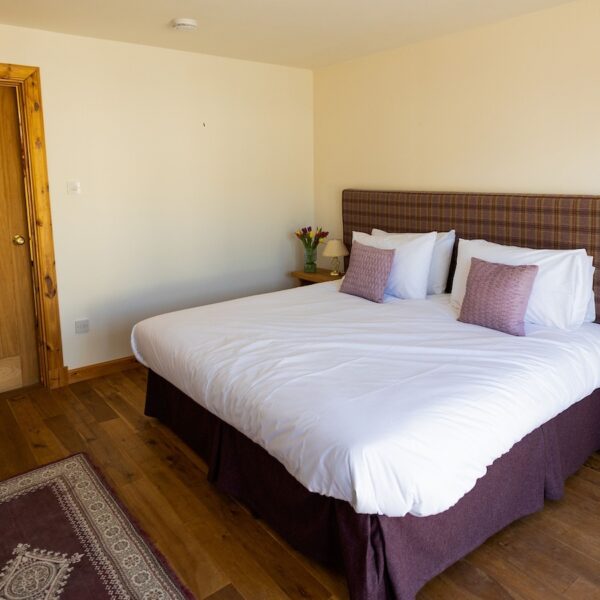 Double bedroom with purple decor in Balvraid Steading, near Dornoch