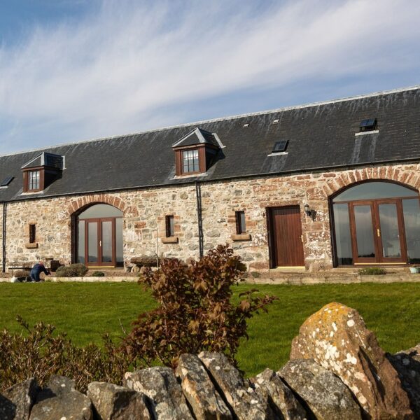 South facing exterior of Balvraid Steading, near Dornoch with arched patio doors