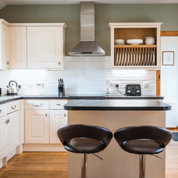 Kitchen with island and two stools in Grieve's Cottage, Skelbo Dornoch