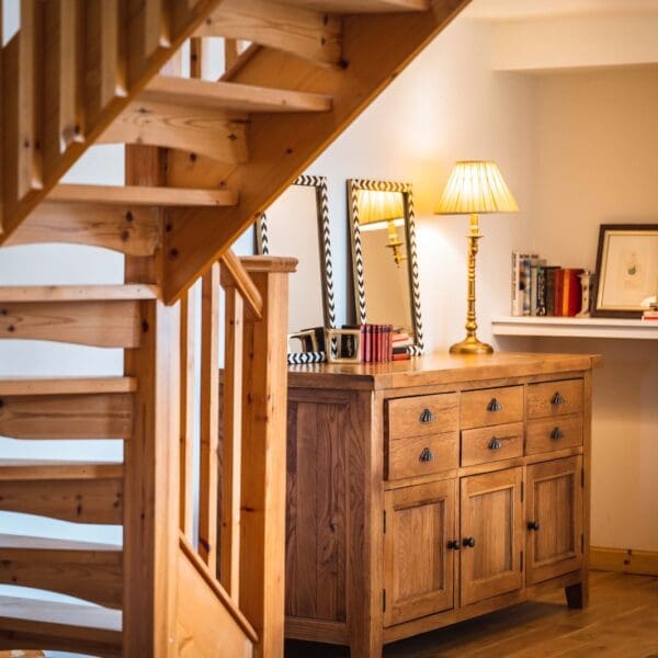 Interior hallway and staircase with lit lamp in Grieve's Cottage, Skelbo Dornoch