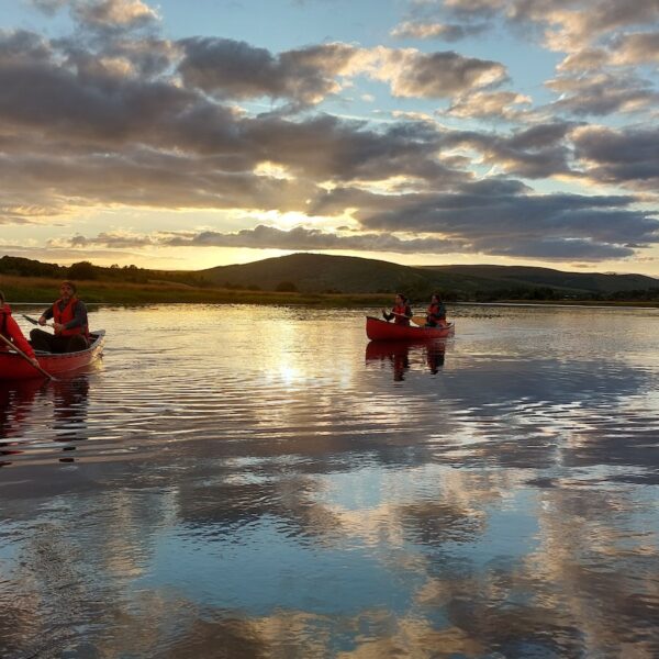 Canoeing on loch in low sun, Go Wild Highlands, Lairg