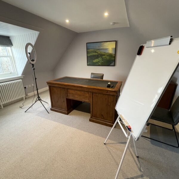 Office room in 2 Quail, Dornoch with grey decor, wooden writing desk and whiteboard