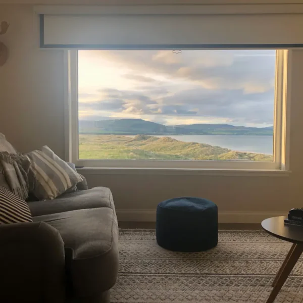 Interior of lounge with window view Seashells holiday cottage, Embo