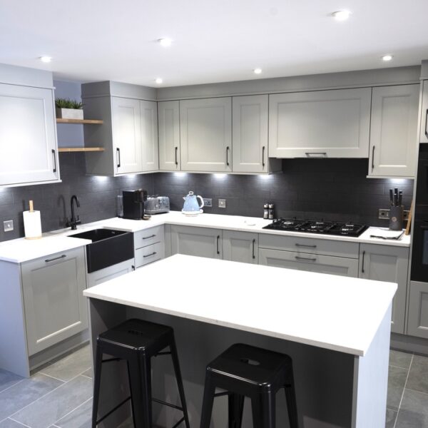 Kitchen with modern grey cabinets and island with black stools in 2 Quail, Dornoch