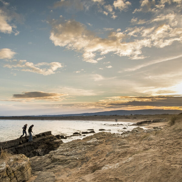 People climbing rocks at Dornoch Beach