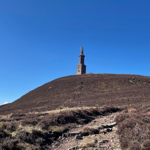 Ben Bhraggie hill with statue on clear sunny day