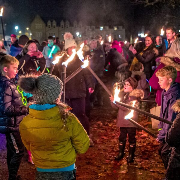 Children with torches for torchlit parade on Bonfire Night, Dornoch Square, Dornoch