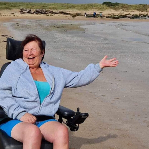 Lady in wheelchair on dornoch beach