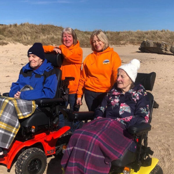 Dornoch Beach wheelchairs charity group on beach