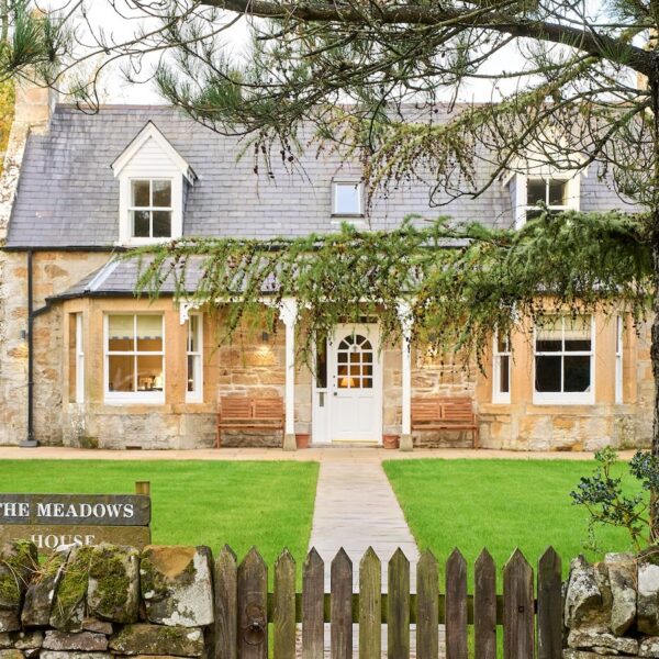 Exterior of The Meadows, Dornoch with lawned garden, central path and large tree