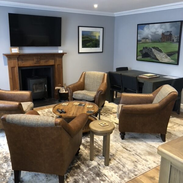 Living area with grey decor and brown leather seating in 2 Quail, Dornoch