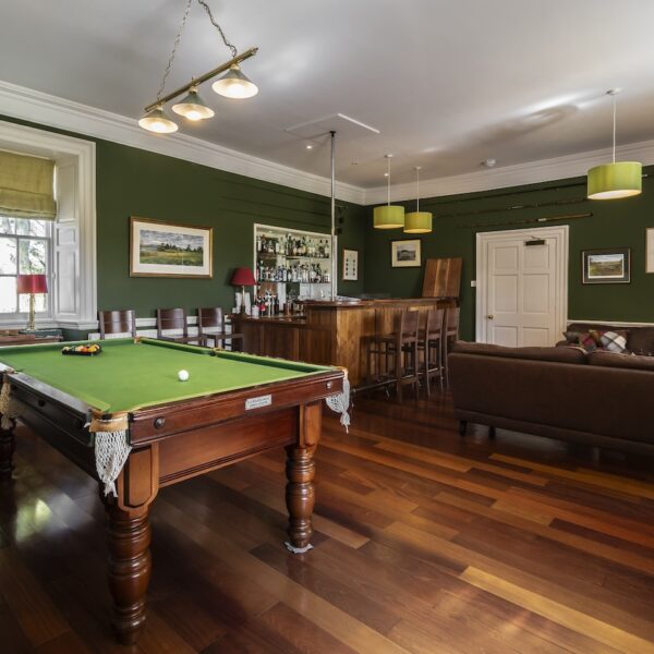 Games room in Embo House, Dornoch with bar, couches and pool table