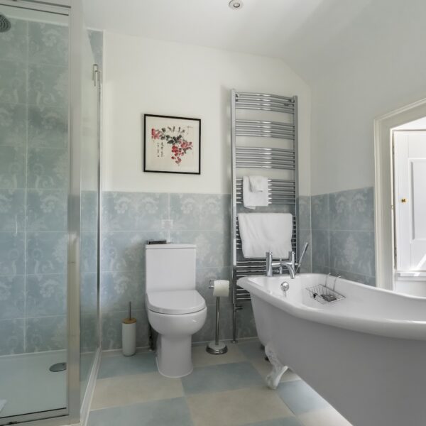 Bath and shower room in Embo House, Dornoch with roll-top slipper bath