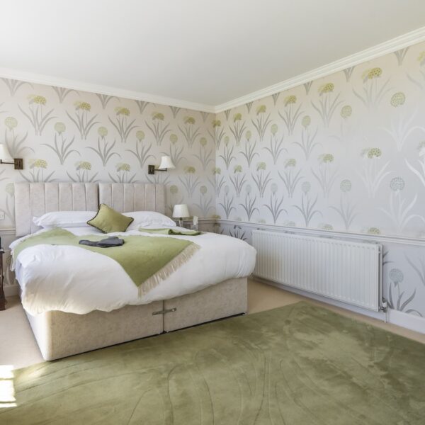 Bedroom in Embo House, Dornoch with green floor rug