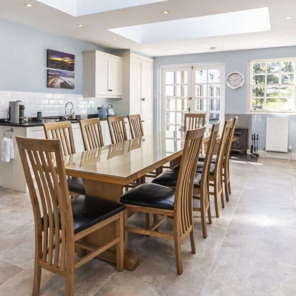 Kitchen of Embo House, Dornoch with wooden dining table and pale blue walls