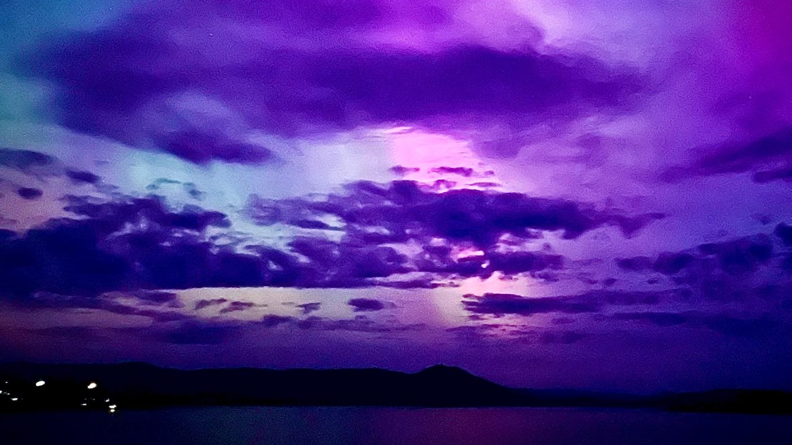 Purple and pink northern lights over Dornoch Firth