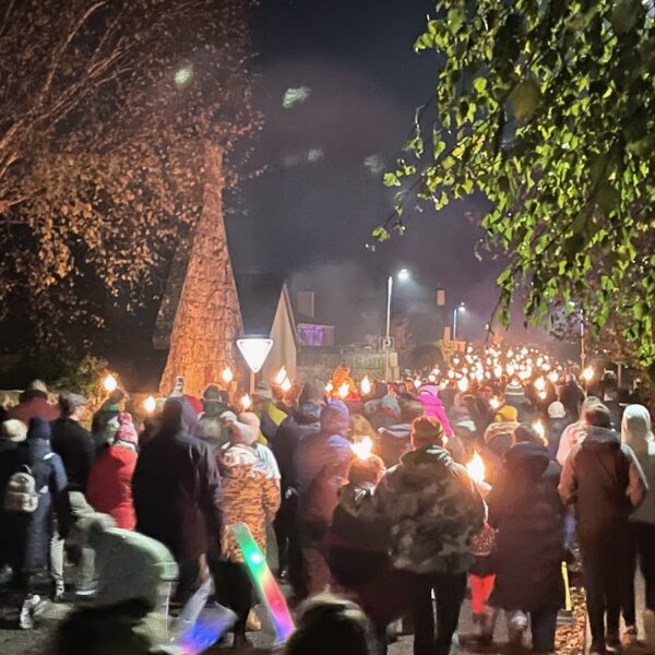 people walking with lit torches in torchlit parade, Dornoch on Bonfire Night