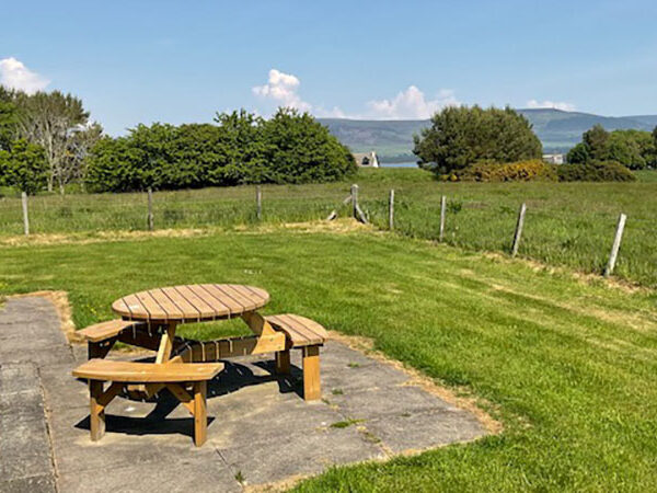 Seat and table in garden of 25 Skelbo Muir, Dornoch