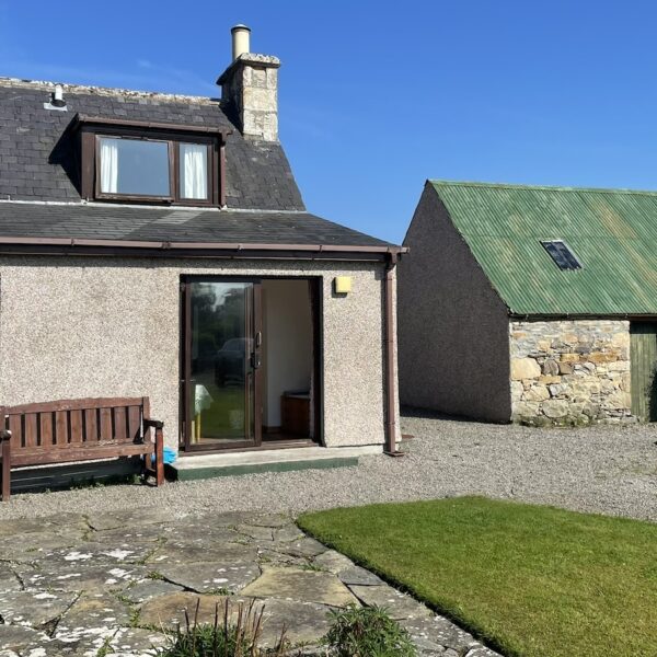 Exterior with barn next door at Achlean Holiday cottage, Dornoch