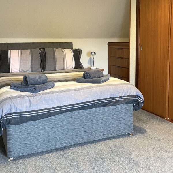 Double bedroom in Oystercatcher, Gate Street, Embo with grey carpet and large built in wardrobes