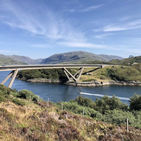 Kylesku Bridge with speadboat on water