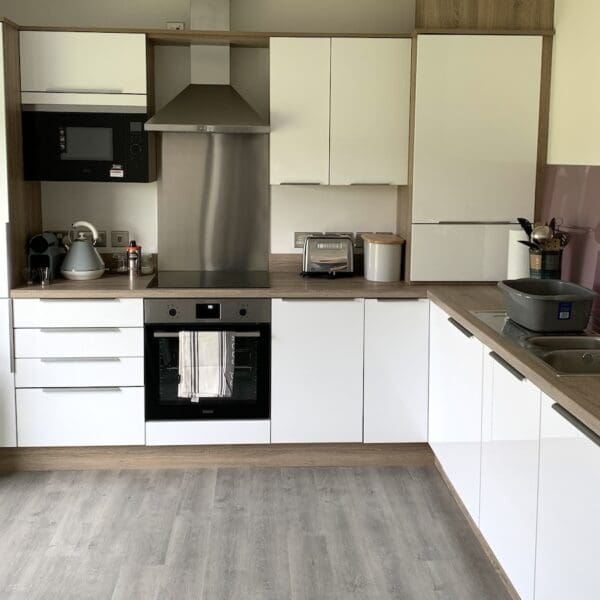 Kitchen of 2 Sorley Avenue, Dornoch with gloss white cabinets and oak counter top