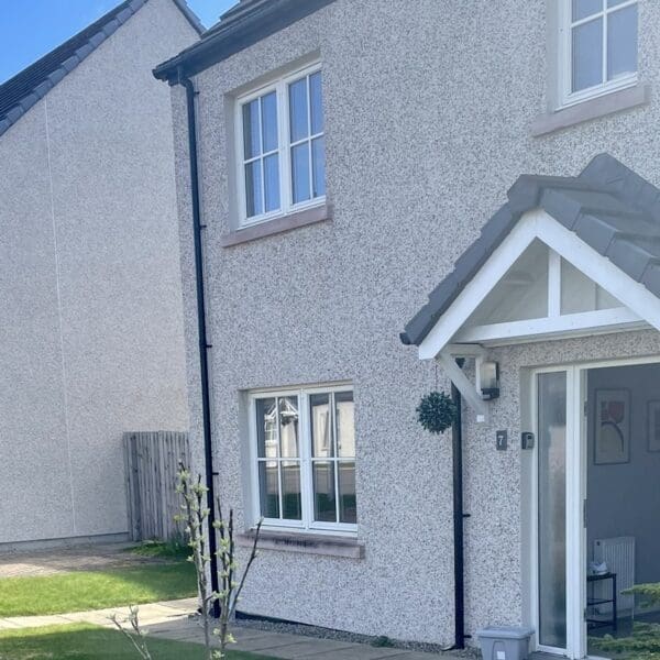 Front exterior of 7 Grant Crescent Dornoch, with light grey harled walls