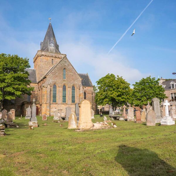 Dornoch Cathedral exterior and graveyard with blue sky