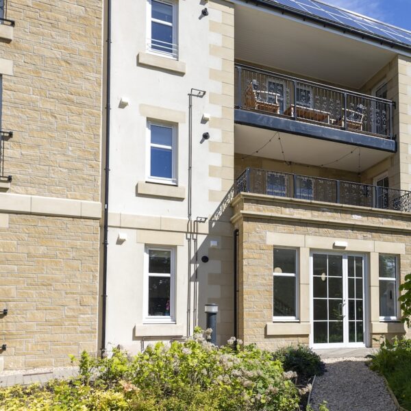 Exterior of Royal Golf Apartments with balconies in Dornoch, Highland, on sunny day