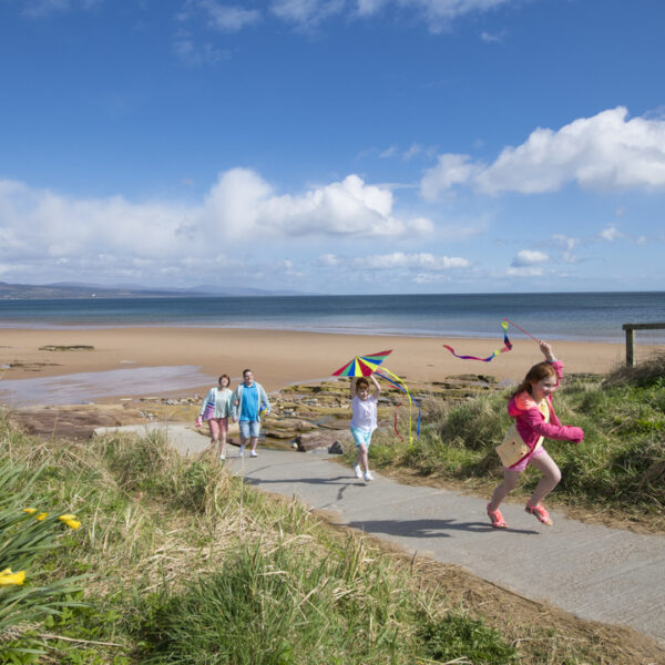 Family on beach with kites at Heilan Haim, Parkdean Resort, Embo